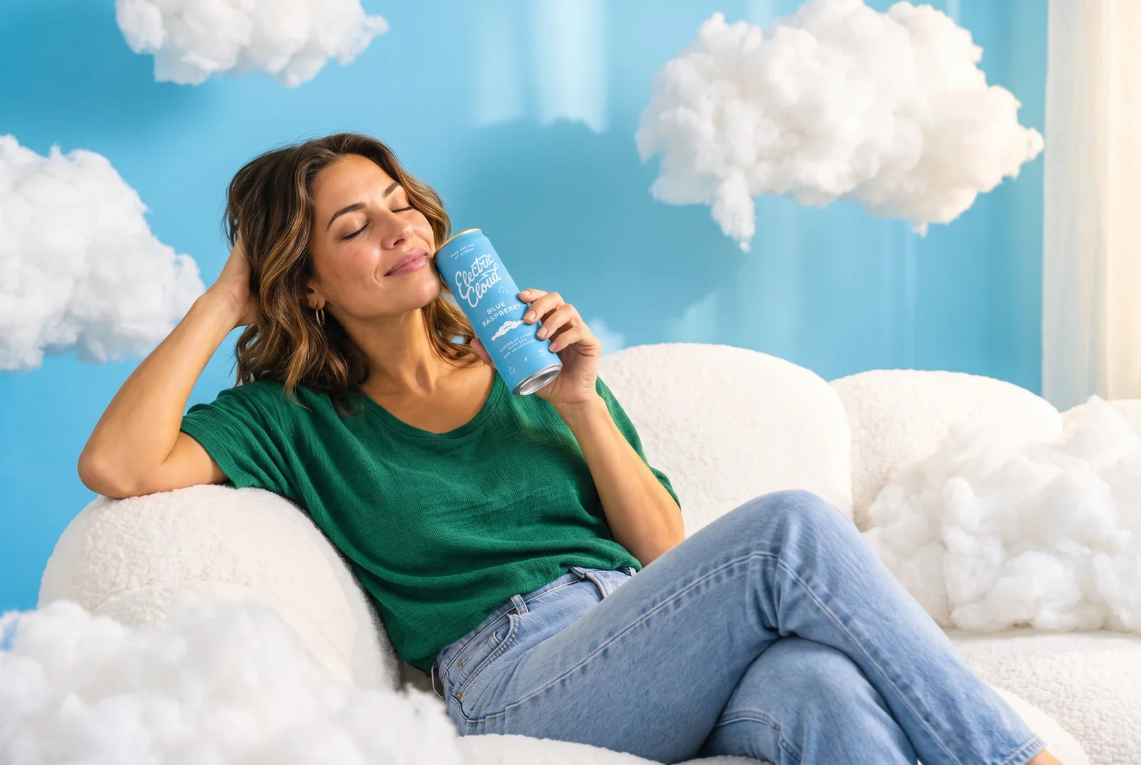 A woman relaxing on a lavender sofa with a Blue Raspberry Electric Cloud