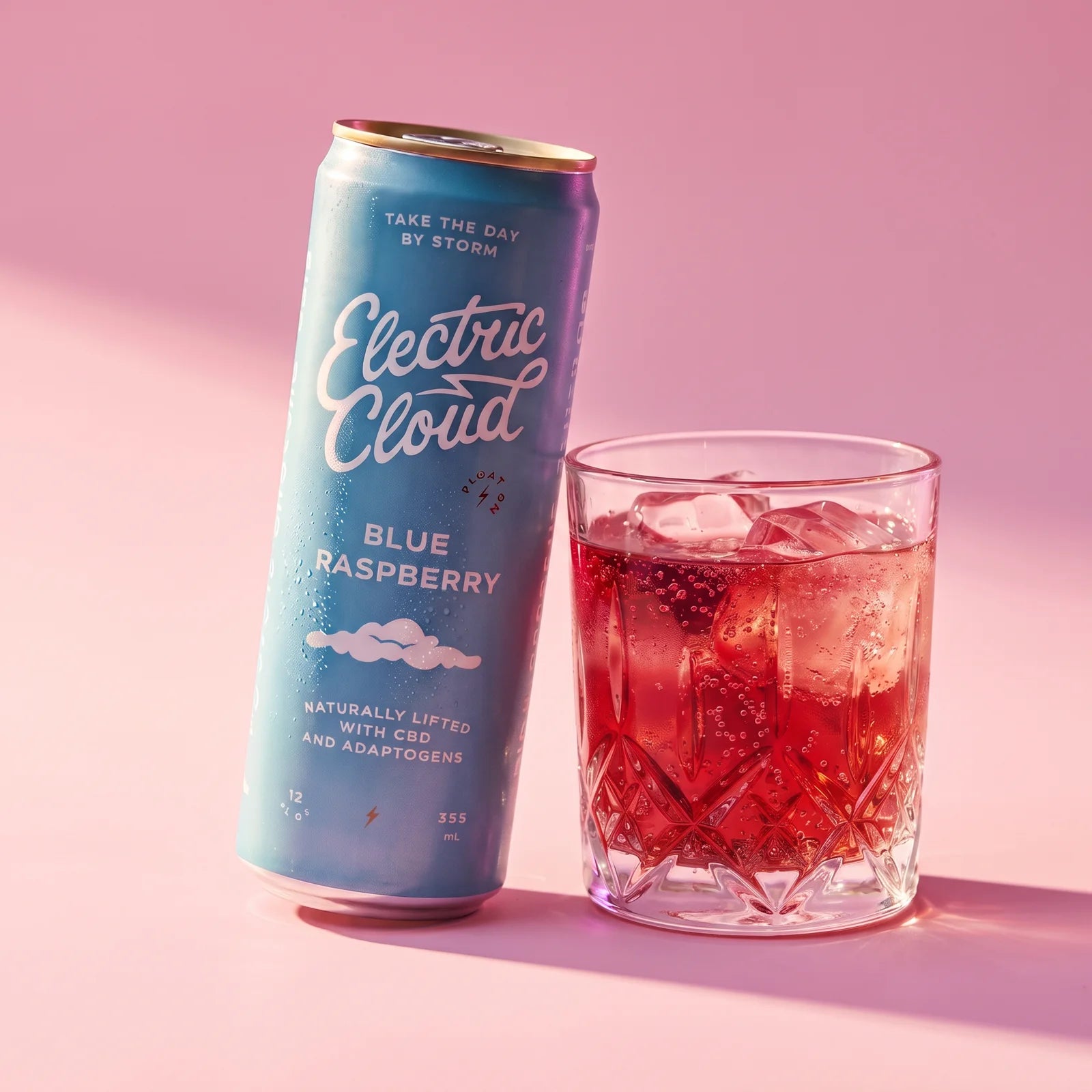 A chilled Blue Raspberry Electric Cloud beside a sparkling drink over ice